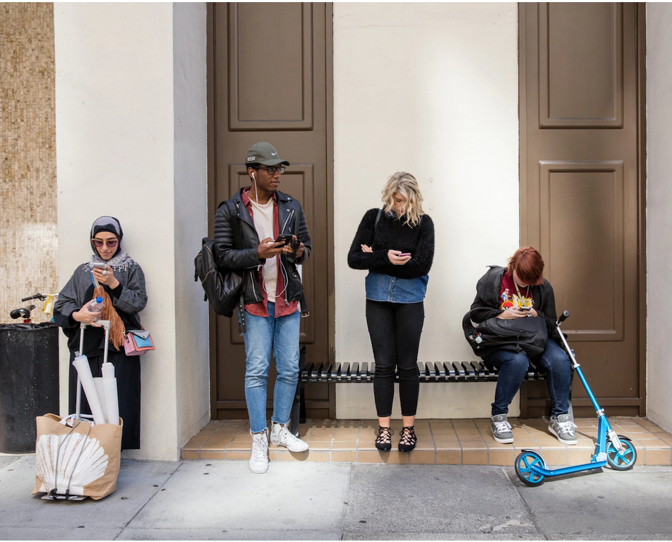 Students wait in front of the Academy of Art in San Francisco